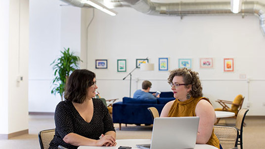 Two women talking at table