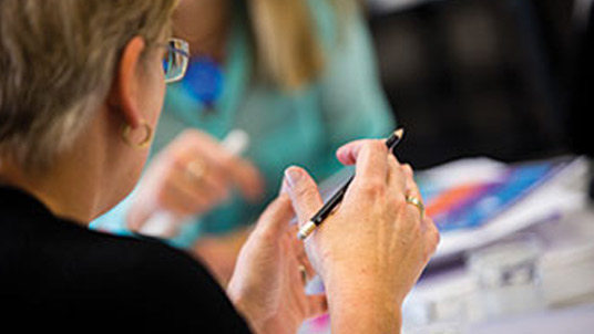 Woman explaining her point in classroom
