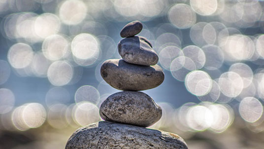 stones piled up with beach in background