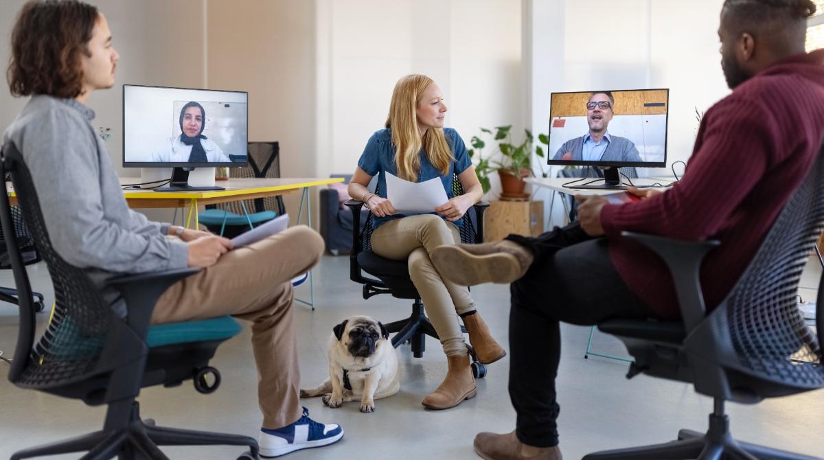 Workers in hybrid office meeting
